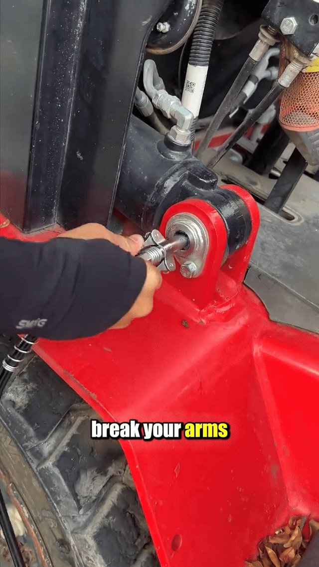 Hand-pumping a grease fitting on a loader the hard way